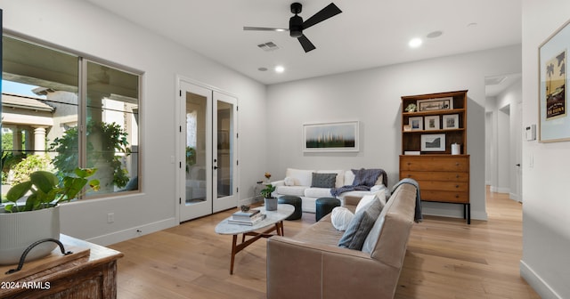 living room with french doors, light hardwood / wood-style flooring, and ceiling fan