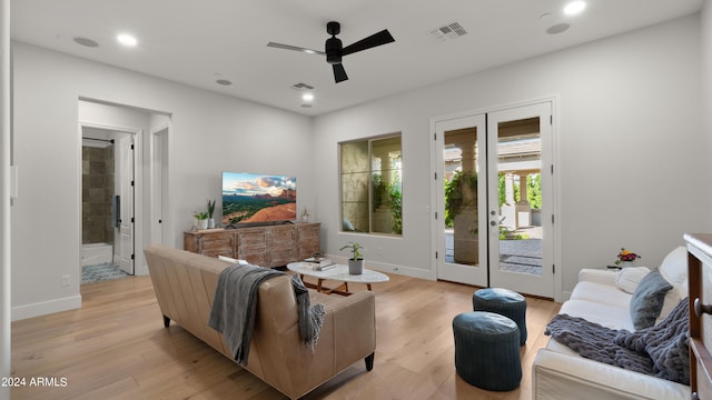 living room with french doors, light hardwood / wood-style floors, and ceiling fan