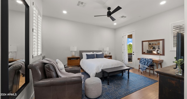 bedroom with access to exterior, wood-type flooring, and ceiling fan