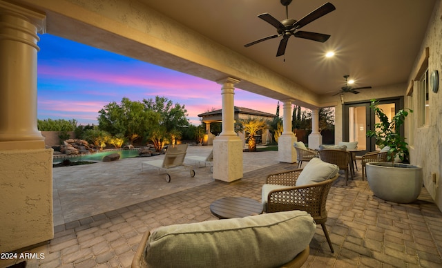 patio terrace at dusk featuring a gazebo and ceiling fan