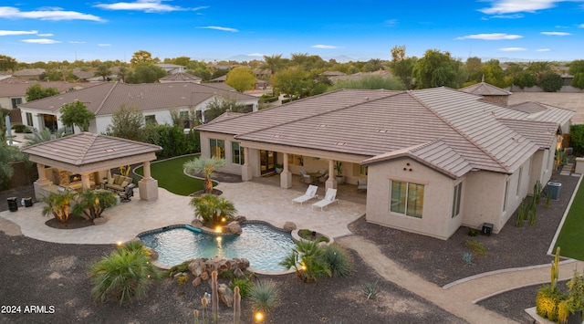 rear view of property with central air condition unit and a patio area