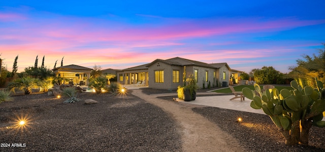 view of back house at dusk