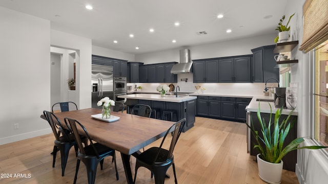 dining space with sink and light wood-type flooring