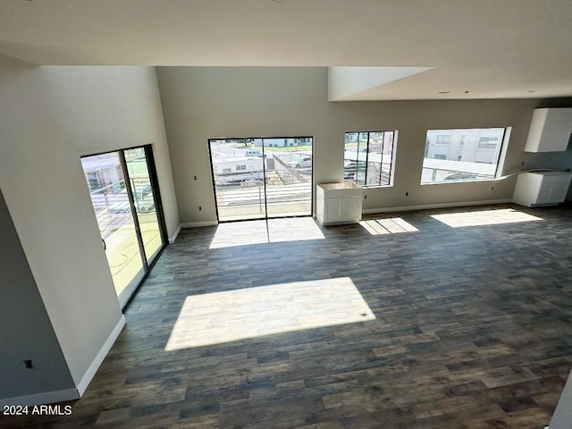 unfurnished living room featuring a high ceiling