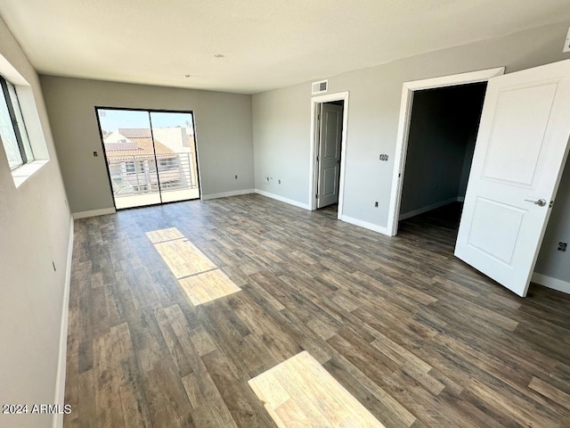 unfurnished room featuring dark wood-type flooring