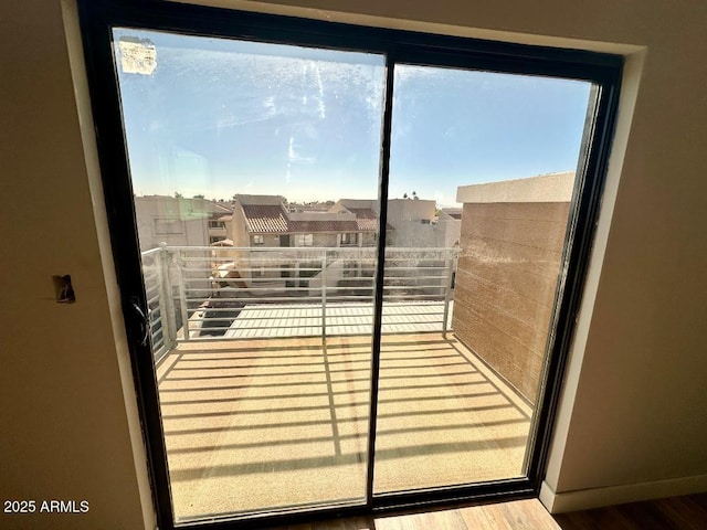 doorway with hardwood / wood-style flooring