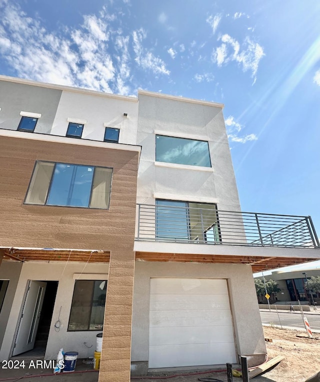 exterior space featuring a balcony and a garage