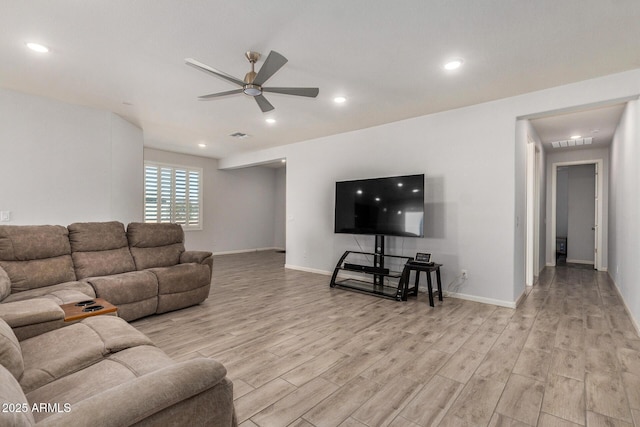 living room with ceiling fan and light hardwood / wood-style floors