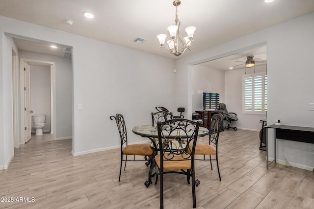 dining area featuring ceiling fan with notable chandelier