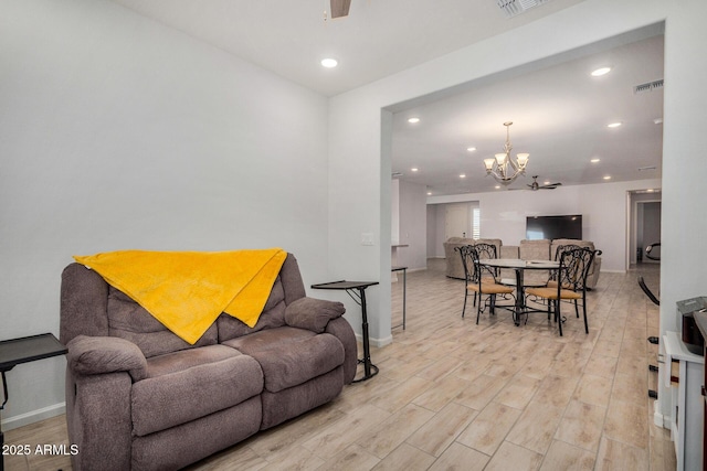 living room featuring light hardwood / wood-style flooring and a notable chandelier