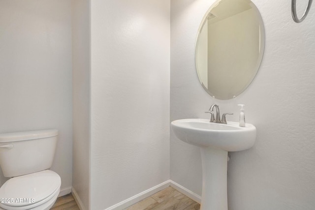 bathroom featuring toilet and hardwood / wood-style floors