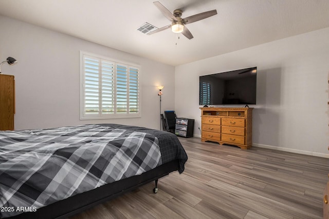 bedroom with ceiling fan and hardwood / wood-style flooring