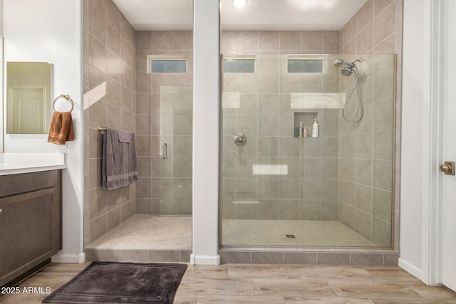 bathroom with an enclosed shower, vanity, and hardwood / wood-style flooring