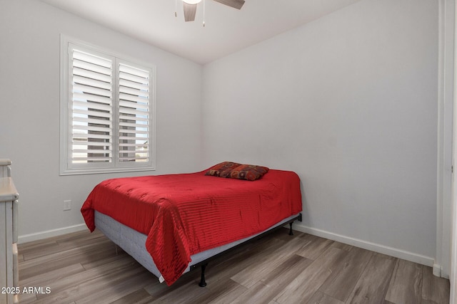 bedroom with ceiling fan and hardwood / wood-style floors