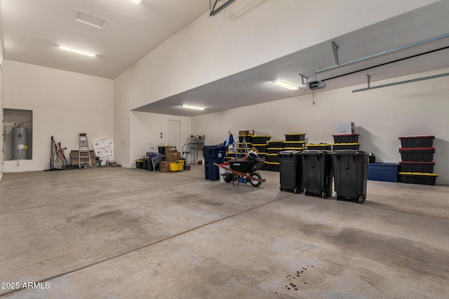 garage with water heater and a garage door opener