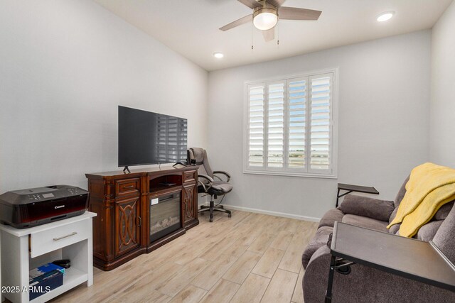 home office with ceiling fan and light hardwood / wood-style floors