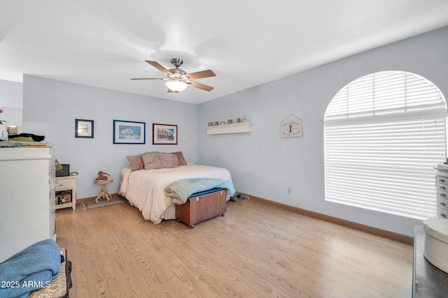 bedroom with light wood-style floors, baseboards, and a ceiling fan