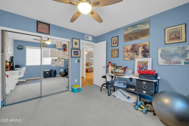 interior space featuring carpet, visible vents, and ceiling fan