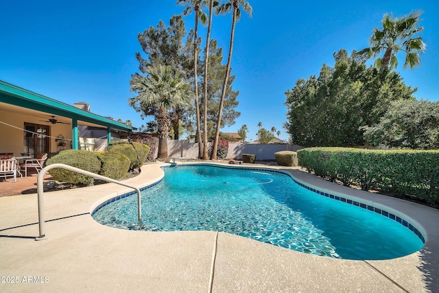 view of swimming pool featuring a fenced in pool, a fenced backyard, a patio, and ceiling fan