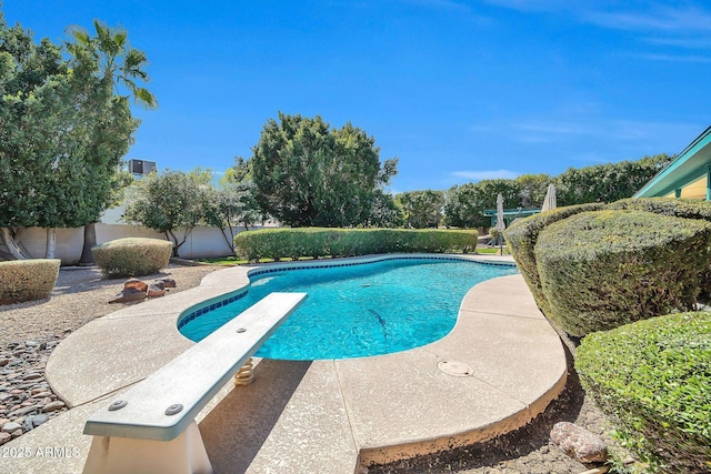 view of pool featuring a diving board, a patio area, a fenced backyard, and a fenced in pool