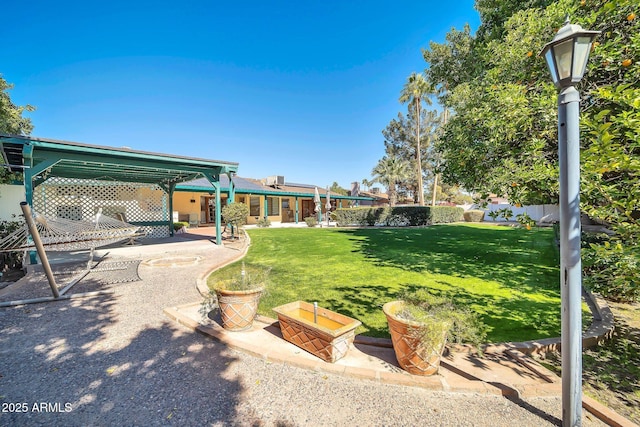 view of yard featuring a patio area, fence, and a pergola