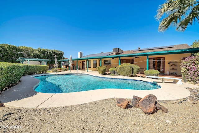 outdoor pool featuring ceiling fan, a diving board, central AC, and a patio