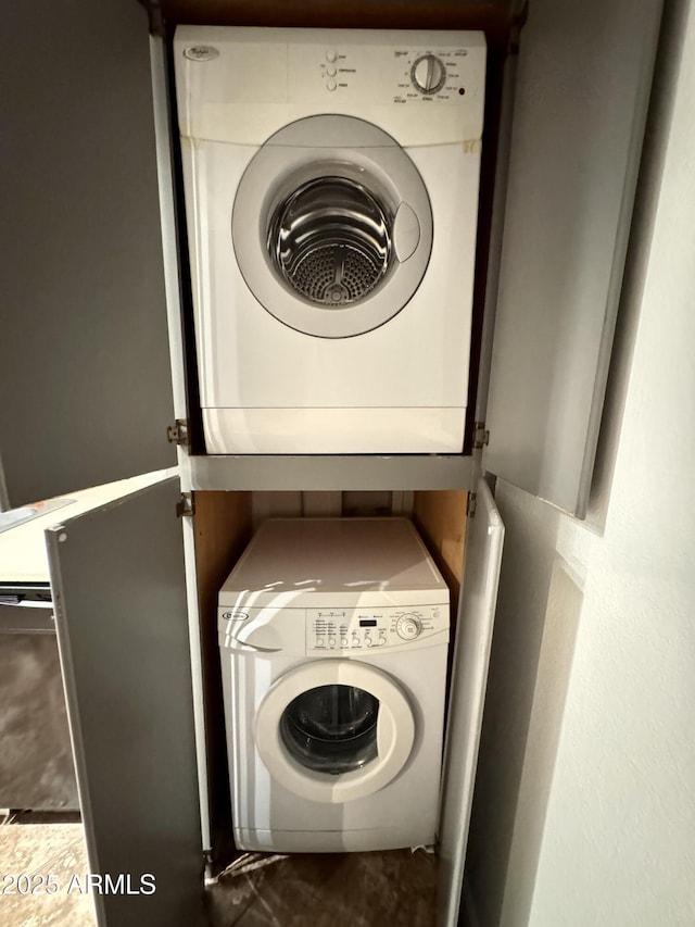 laundry area featuring stacked washer and dryer and laundry area