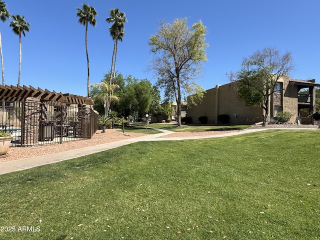 view of community featuring a lawn and a pergola