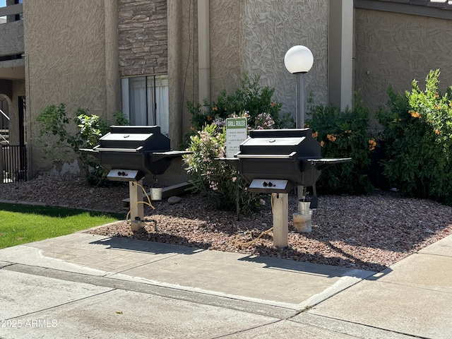 exterior details featuring stone siding and stucco siding