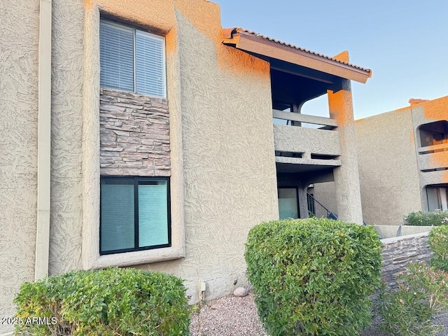 view of home's exterior with stone siding and stucco siding