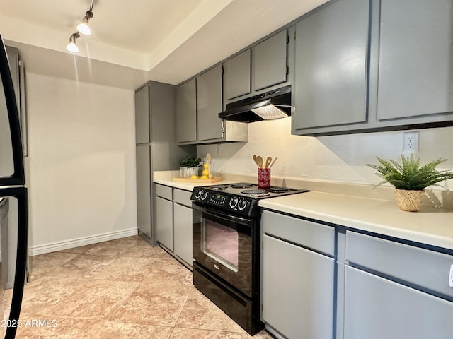 kitchen featuring gray cabinets, light countertops, black appliances, under cabinet range hood, and baseboards