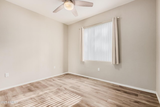 spare room with hardwood / wood-style floors and ceiling fan