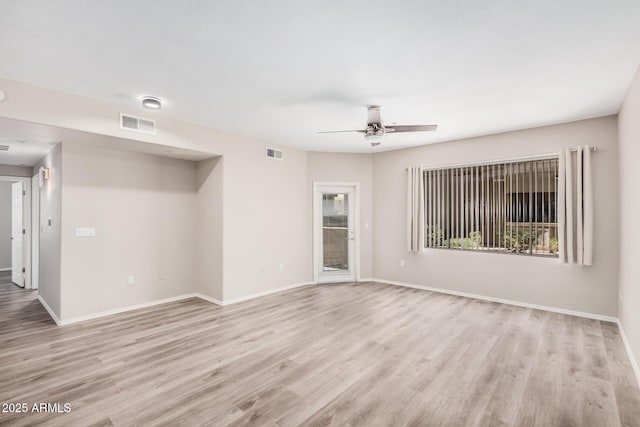 empty room with ceiling fan and light hardwood / wood-style flooring