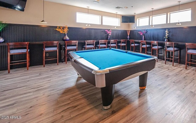 game room featuring hardwood / wood-style floors, bar area, and pool table