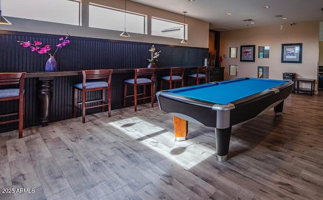 rec room with hardwood / wood-style floors, bar, and pool table