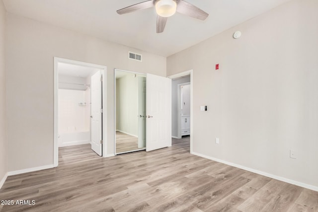 unfurnished bedroom with ceiling fan, ensuite bath, and light hardwood / wood-style floors