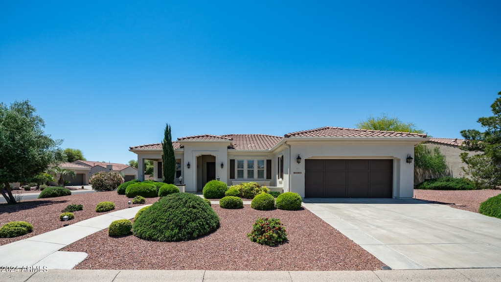 mediterranean / spanish house featuring a garage