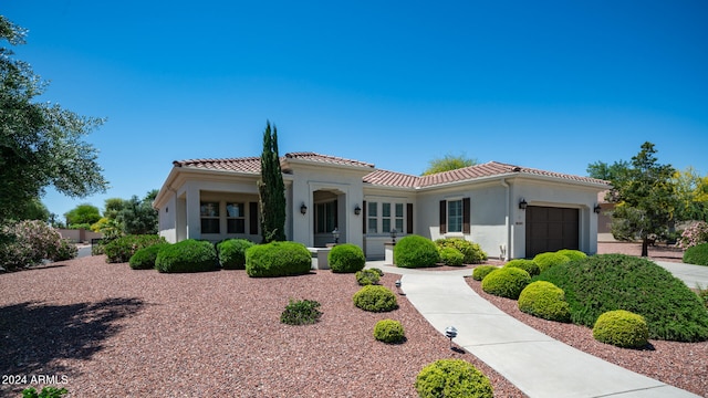 mediterranean / spanish house with a garage