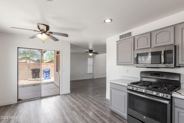 12825 W Virginia Ave, Avondale, AZ 85392 - kitchen with stainless steel appliances, gray cabinets, a ceiling fan, light countertops, and wood finished floors