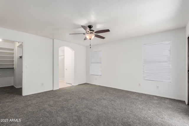 12825 W Virginia Ave, Avondale, AZ 85392 - unfurnished bedroom with carpet floors, arched walkways, a walk in closet, and ensuite bath