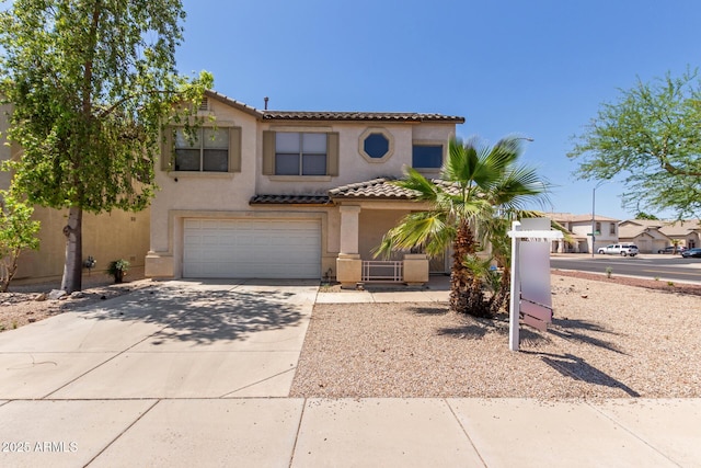 12825 W Virginia Ave, Avondale, AZ 85392 - view of front of house featuring concrete driveway, an attached garage, a tile roof, and stucco siding