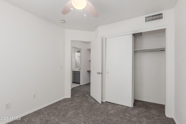 12825 W Virginia Ave, Avondale, AZ 85392 - unfurnished bedroom with dark colored carpet, a closet, and a ceiling fan