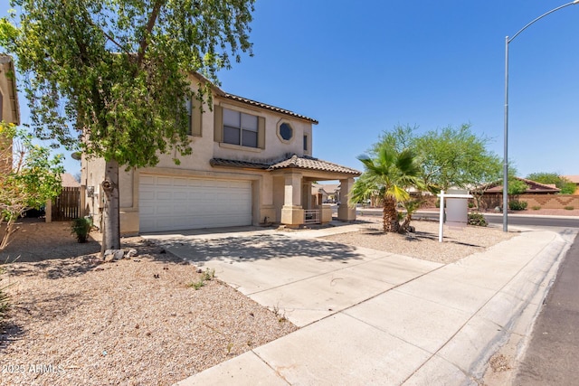 12825 W Virginia Ave, Avondale, AZ 85392 - view of front of home featuring stucco siding, an attached garage, concrete driveway, and a tile roof