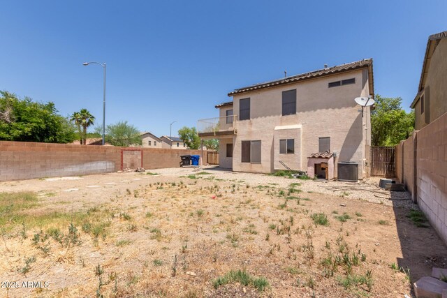 12825 W Virginia Ave, Avondale, AZ 85392 - back of house with a fenced backyard, stucco siding, and a balcony