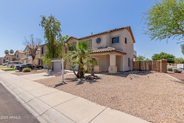12825 W Virginia Ave, Avondale, AZ 85392 - mediterranean / spanish-style house with stucco siding, a tiled roof, a gate, and a residential view