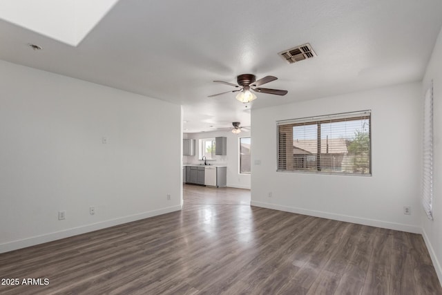 12825 W Virginia Ave, Avondale, AZ 85392 - unfurnished living room featuring dark wood-style floors and a ceiling fan