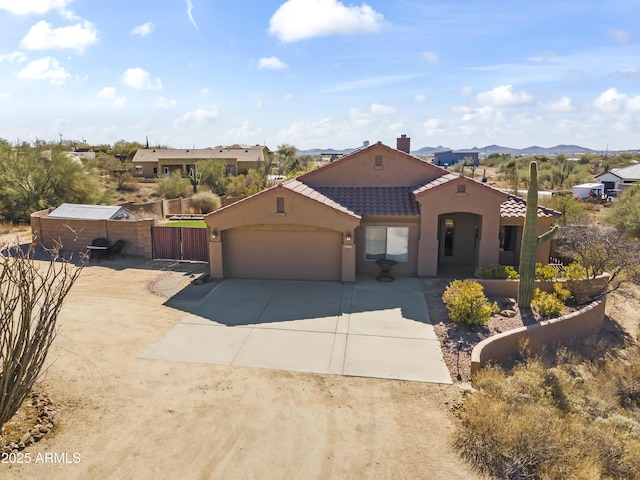 view of front of house featuring a garage and a mountain view