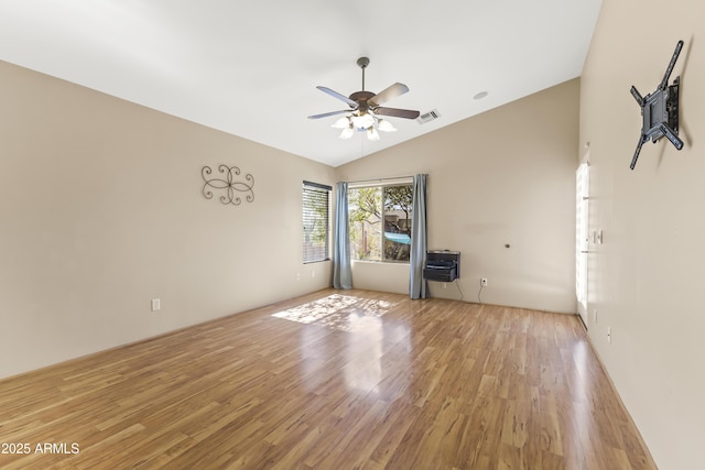 empty room featuring lofted ceiling, light hardwood / wood-style floors, and ceiling fan
