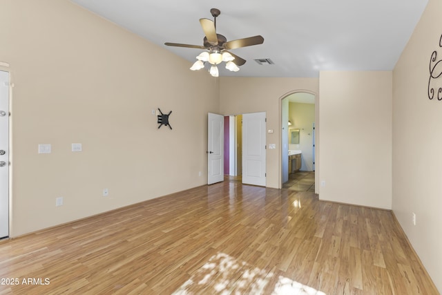 unfurnished room featuring light hardwood / wood-style flooring, ceiling fan, and vaulted ceiling