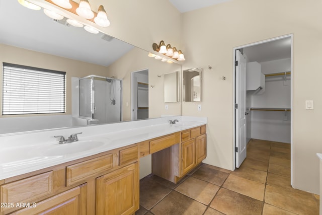 bathroom featuring vanity, tile patterned floors, and a shower with shower door